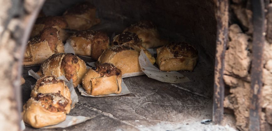 Freshly baked flaounes in a traditional wood-fired oven