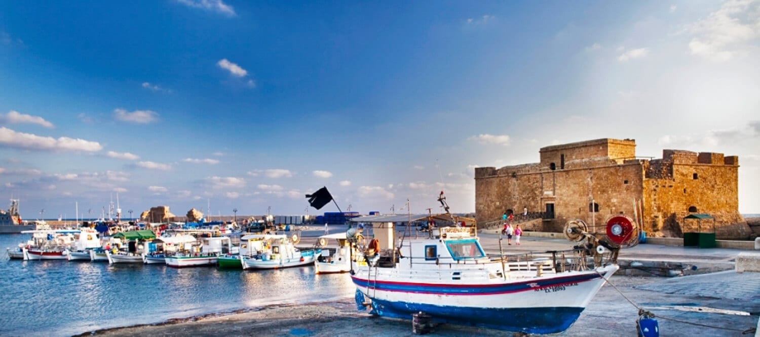 Fishing boats in Paphos harbour in front of the medieval Paphos Castle