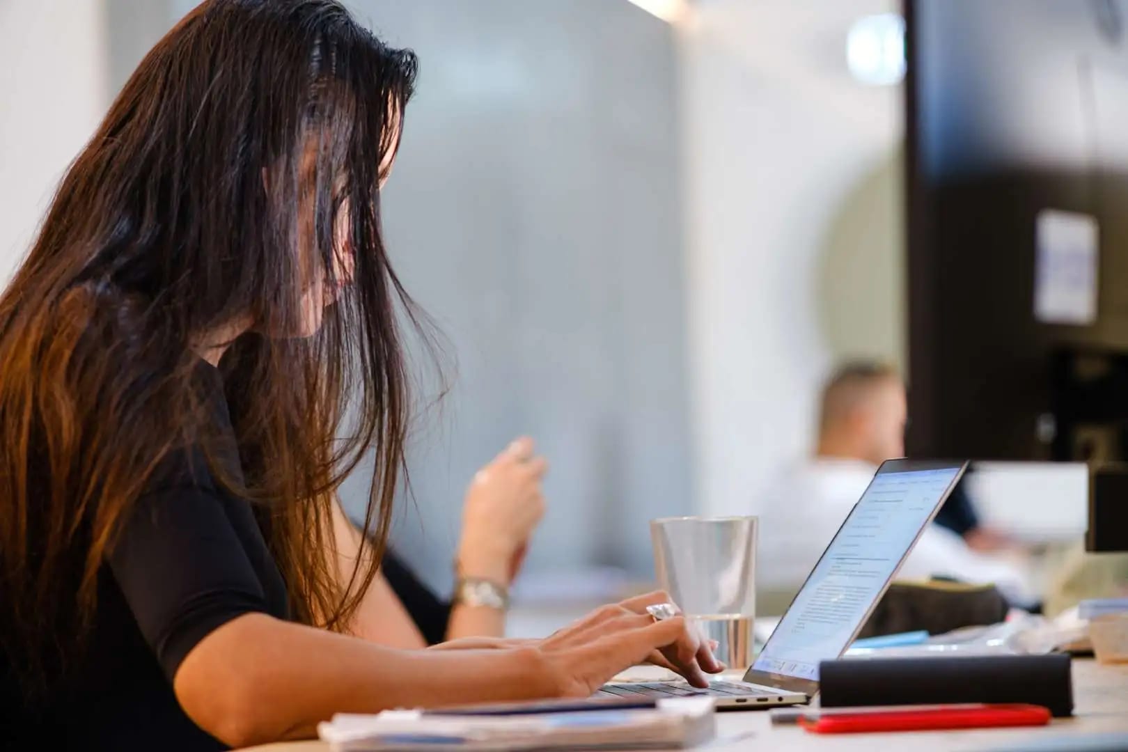 Woman working on a laptop in a shared office